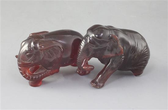 Two natural cherry amber figures of elephants, late 19th/early 20th century, gross weight 275g, one elephant with losses